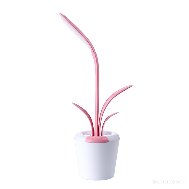 A magenta and white Flowerpot Table Lamp with a built-in USB port for charging devices.